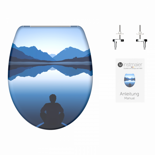 Toilettensitz mit Berg-See-Motiv, Montageset und Anleitung daneben.