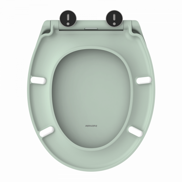 Hellgrüner Toilettensitz in ovaler Form mit weißen Pufferauflagen und schwarzen Scharnieren.