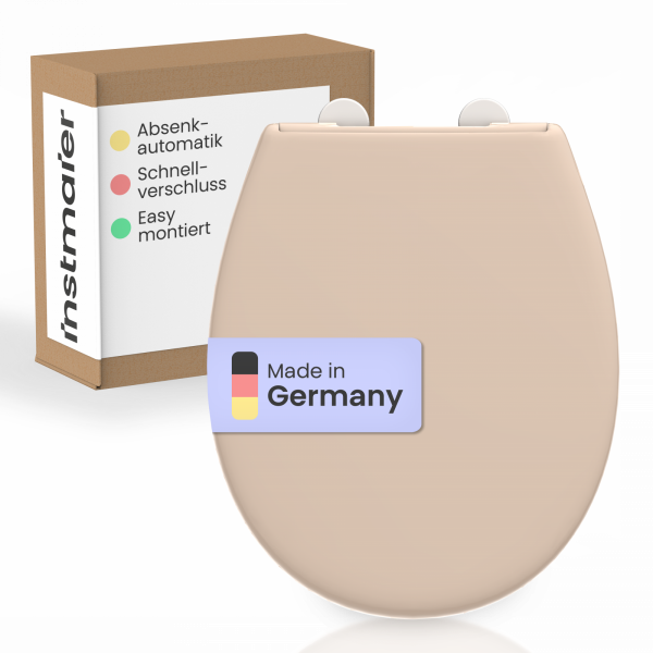 Beiger WC-Sitz mit Aufkleber „Made in Germany“ vor Verpackung mit Funktionshinweisen.