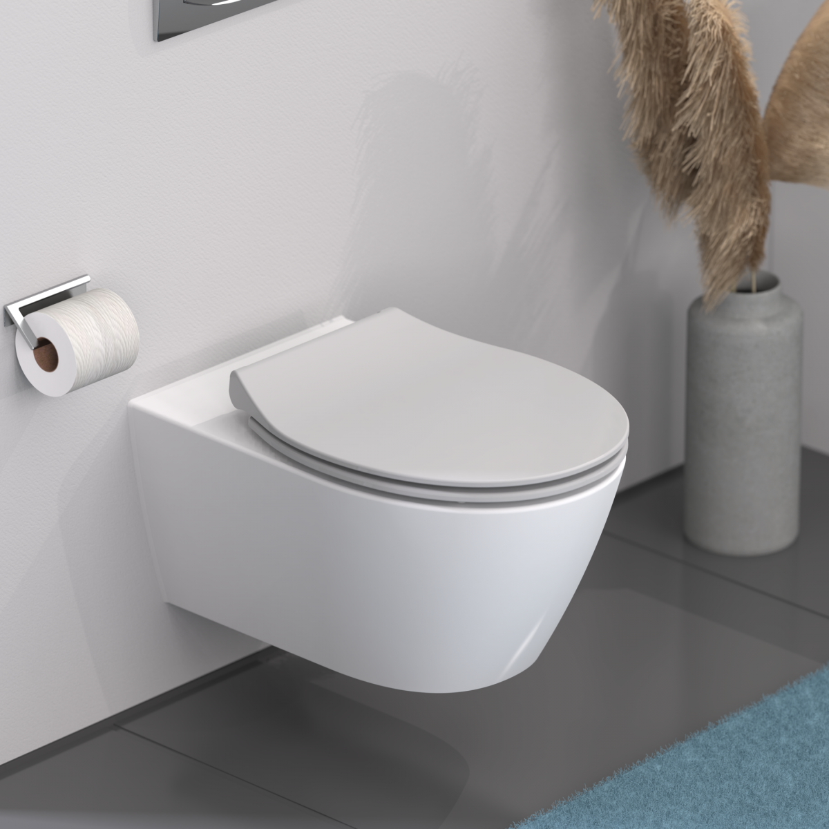 Wandhängendes WC mit geschlossenem Deckel neben Toilettenpapierhalter und Vase mit Gräsern.